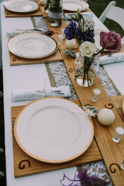Rustic table setting with wood branded chargers and runner