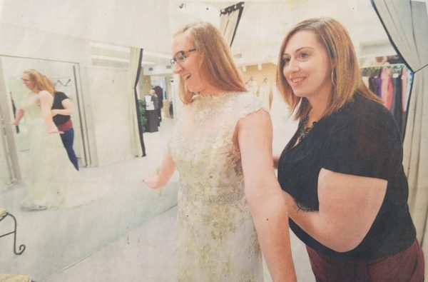 Planner helping bride with her dress before the ceremony